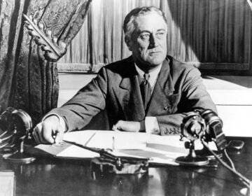 In this March 1933, file photo, President Franklin D. Roosevelt delivers his first radio 