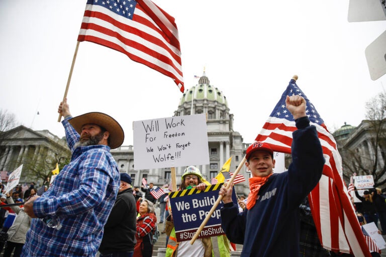 Protesters demonstrate at the state Capitol in Harrisburg, Pa., Monday, April 20, 2020, demanding that Gov. Tom Wolf reopen Pennsylvania's economy even as new social-distancing mandates took effect at stores and other commercial buildings. (AP Photo/Matt Rourke)