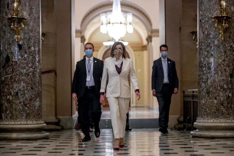 In this April 23, 2020 photo House Speaker Nancy Pelosi of Calif., walks to her office after signing the Paycheck Protection Program and Health Care Enhancement Act, H.R. 266, after it passed the House on Capitol Hill in Washington. (Andrew Harnik/AP Photo)