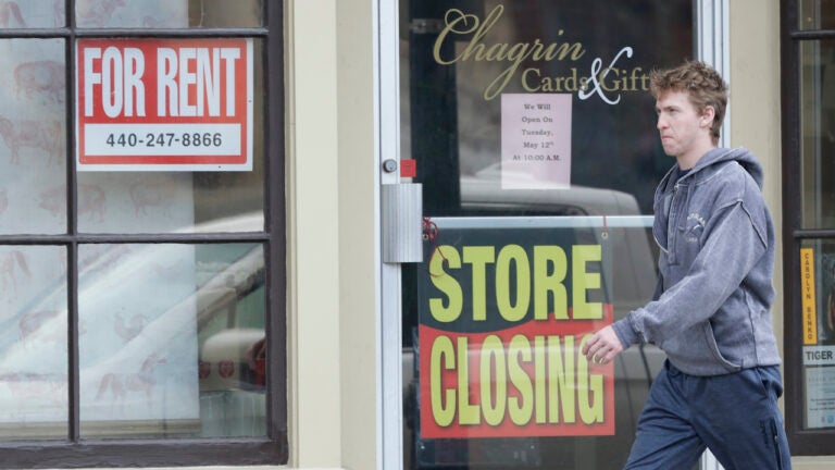 Man walks past closed business amid coronavirus pandemic.