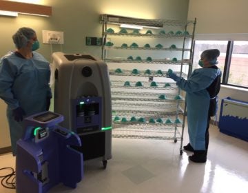 Doylestown Health workers place used N95 masks on a rack for HPV sanitation. (Courtesy of Ron Watson/Doylestown Health)