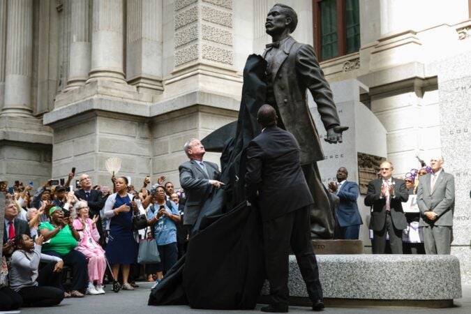 Philadelphia Mayor Jim Kenney (center) and sculptor Branly Cadet unveil a statue of Octavius Valentine Catto at City Hall in Philadelphia, Tuesday, Sept. 26, 2017. A century before the fight to end Jim Crow segregation laws, Octavius Valentine Catto was leading a civil rights movement in Philadelphia. (AP Photo/Matt Rourke)