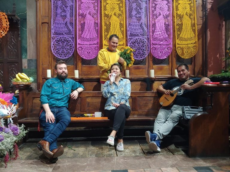  Rob Buscher (left on first row) seated with members of Calaca Flaca,Dia, the artist committee that organizes de Los Muertos altar in Fleisher's Sanctuary, the largest public event held annually at the nonprofit community art school. (Courtesy: Rob Buscher/ Photo credit: Gustavo Gonzales)