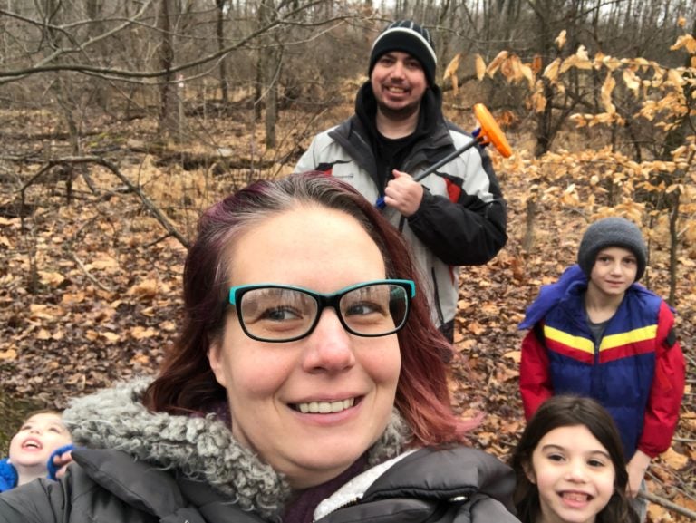 Dawn Sites with her family in the woods behind her house. Her son Jaiden wears a blue, red and yellow jacket. (Courtesy of Dawn Sites)
