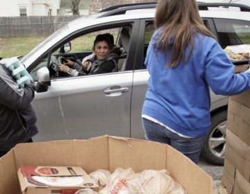 Together Inc. food bank workers distribute food at a drive-through location in Omaha, Neb., last week. Disruptions in the agricultural supply chain caused by the coronavirus pandemic are making it difficult for food banks. (Nati Harnik/AP Photo)