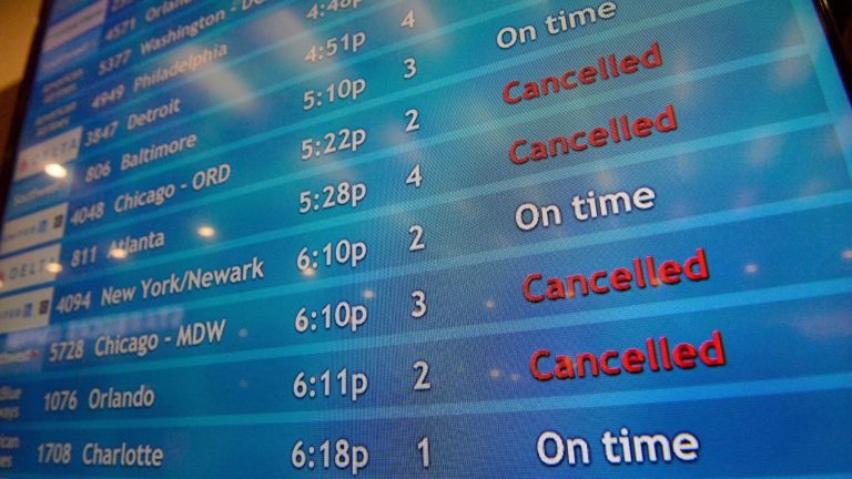 A screen shows canceled incoming flights at TF Green International Airport in Warwick, R.I. on March 30, 2020, during the novel coronavirus outbreak. (Joseph Prezioso /AFP via Getty Images)
