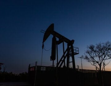 Producers have kept pumping oil, even if they're not making money, partly because wells — once shut down — can be difficult to get back up and running. Here, a pump jack operates at Willow Springs Park in Long Beach, Calif. (Apu Gomes/AFP via Getty Images)