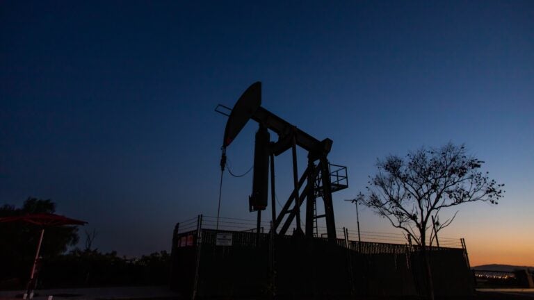 Producers have kept pumping oil, even if they're not making money, partly because wells — once shut down — can be difficult to get back up and running. Here, a pump jack operates at Willow Springs Park in Long Beach, Calif. (Apu Gomes/AFP via Getty Images)