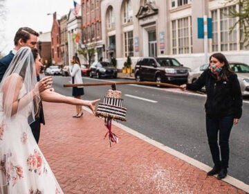 Jessica Heaven and Adam Kasprak getting a 'cake' from a friend at their April 17 wedding. (Joel Todero/Courtesy of Jessica Heaven and Adam Kasprak) 