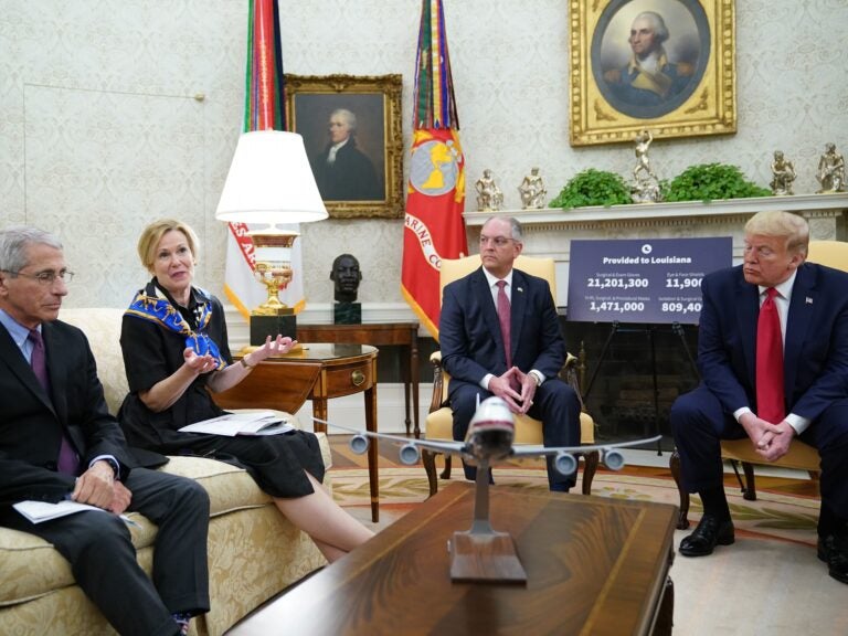 Dr. Anthony Fauci, left, director of the National Institute of Allergy and Infectious Diseases, listens as Dr. Deborah Birx, head of the White House coronavirus task force, talks during an Oval Office meeting with President Trump and Louisiana Gov. John Bel Edwards on Wednesday. (Mandel Ngan/AFP via Getty Images)
