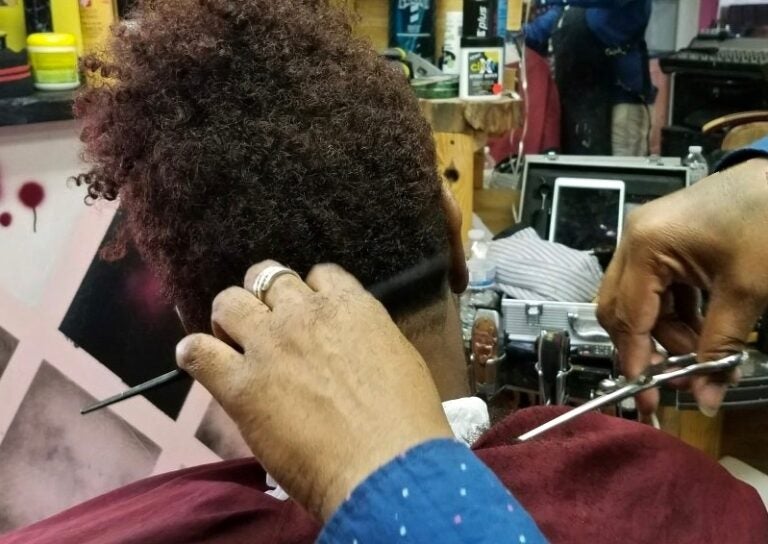 The Pennsylvania government doesn’t consider barbershop essential businesses. But some people who work in them, and who visit, disagree. (Andrea Gibbs/WHYY)