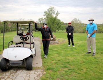 Golfers practice social distancing at Juniata Golf Club. Chet Turner (right) of Yardley, Pa., played the course Sunday morning with his brother, Bernard (left) and friend, Eric Hill. (Emma Lee/WHYY)