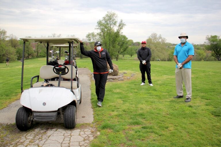 Golfers practice social distancing at Juniata Golf Club. Chet Turner (right) of Yardley, Pa., played the course Sunday morning with his brother, Bernard (left) and friend, Eric Hill. (Emma Lee/WHYY)