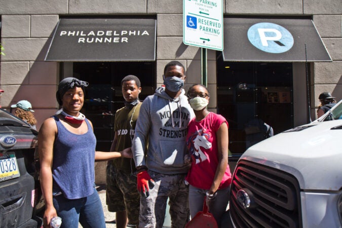 Cerrone Brown brought his three children to Center City from the Northeast section of Philadelphia to assist in clean-up after riots broke out in the city Saturday night.