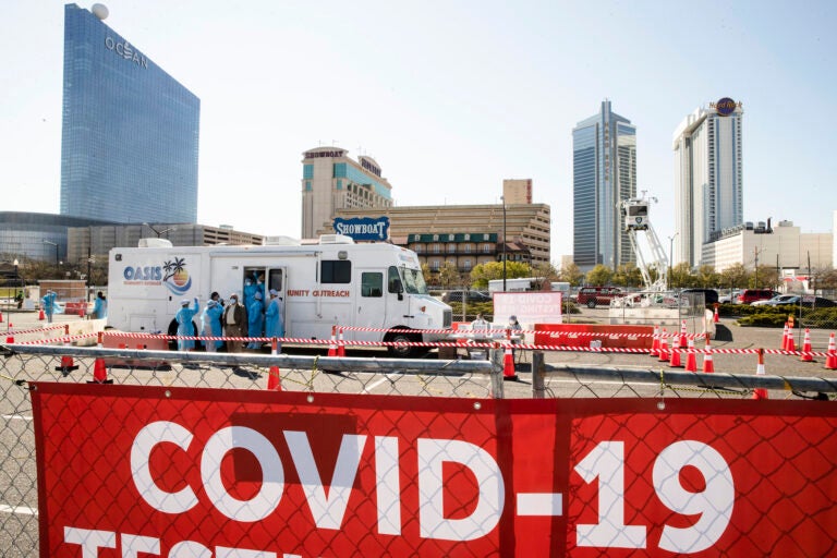 Medical workers prepare for the opening of a COVID-19 test location in a parking lot near the casinos in Atlantic City, Pa., Tuesday, April 28, 2020. (AP Photo/Matt Rourke)