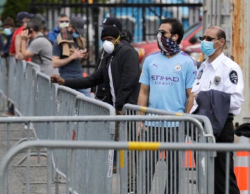 People wait in line to be tested for the new coronavirus at a testing site in Jersey City, N.J., Monday, May 4, 2020. (AP Photo/Seth Wenig)