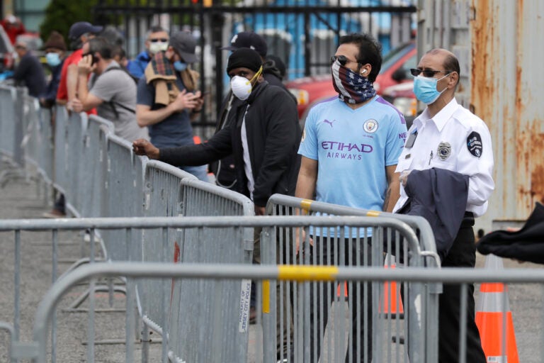 People wait in line to be tested for the new coronavirus at a testing site in Jersey City, N.J., Monday, May 4, 2020. (AP Photo/Seth Wenig)