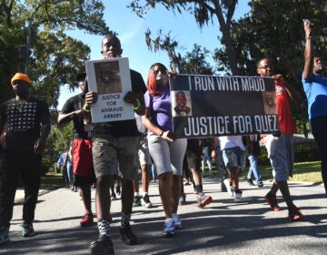 In this Tuesday, May 5, 2020, photo, a crowd marches through a neighborhood in Brunswick, Ga. They were demanding answers in the death of Ahmaud Arbery. (Bobby Haven/The Brunswick News via AP)