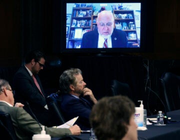 Senators and staff listen to Dr. Robert Redfield director of the Centers for Disease Control and Prevention speak remotely during a Senate Health, Education, Labor and Pensions Committee hearing on Capitol Hill on May 12, 2020 in Washington, DC. (Win McNamee/Pool via AP)