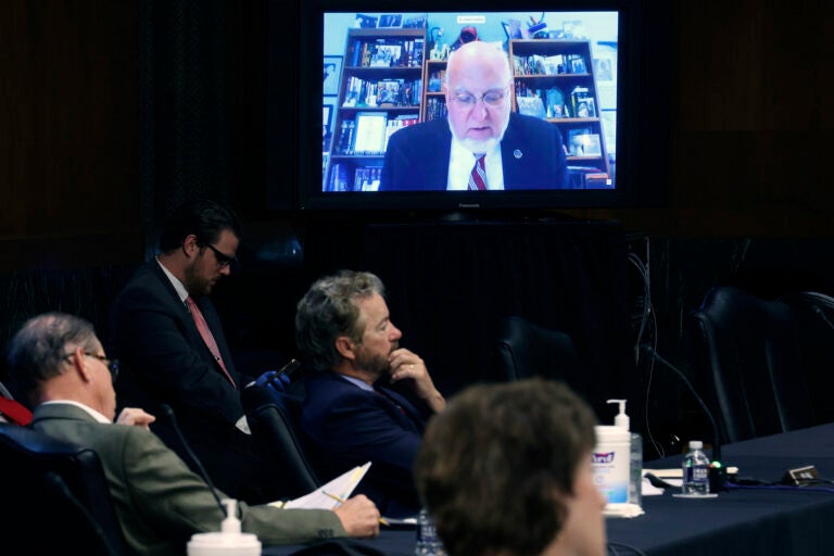 Senators and staff listen to Dr. Robert Redfield director of the Centers for Disease Control and Prevention speak remotely during a Senate Health, Education, Labor and Pensions Committee hearing on Capitol Hill on May 12, 2020 in Washington, DC. (Win McNamee/Pool via AP)