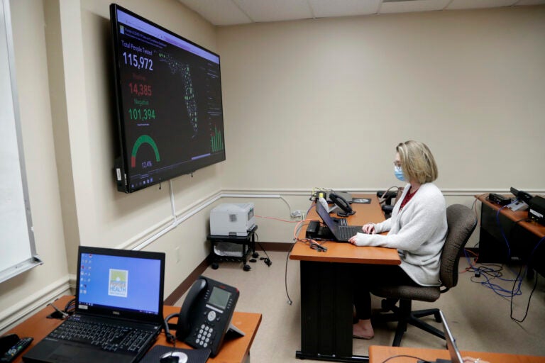 In this Wednesday, May 13, 2020 photo, Meghan Peck works on contact tracing at the Florida Dept. of Health in Miami-Dade County, during the new coronavirus pandemic, in Doral, Fla. (AP Photo/Lynne Sladky)