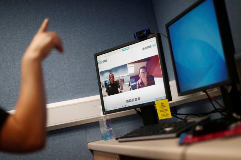 Professionals are turning to Zoom to carry out work typically done in person. (Hannah McKay/Pool Photo via AP)