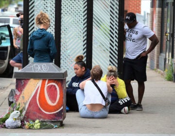 Mourners gather around a makeshift memorial, Tuesday, May 26, 2020 in Minneapolis, near where an black man was taken into police custody the day before who later died. (AP Photo/Jim Mone)