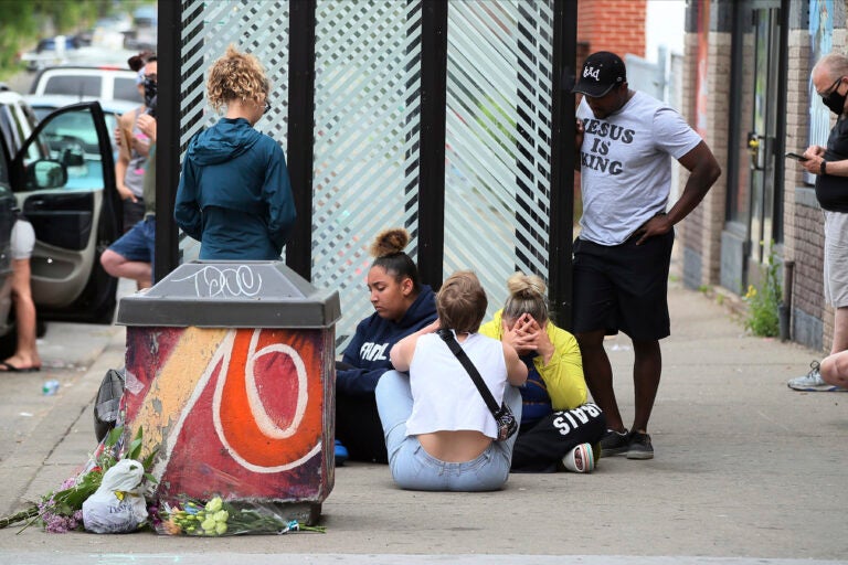 Mourners gather around a makeshift memorial, Tuesday, May 26, 2020 in Minneapolis, near where an black man was taken into police custody the day before who later died. (AP Photo/Jim Mone)
