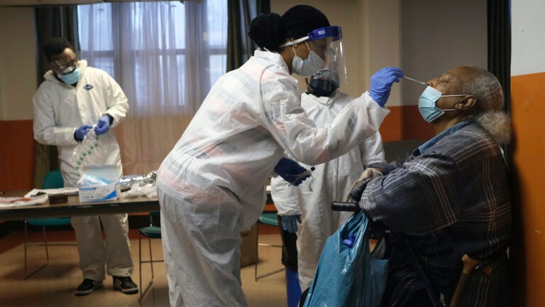 Mary Mack, right, a resident of senior housing, is tested for COVID-19 in Paterson