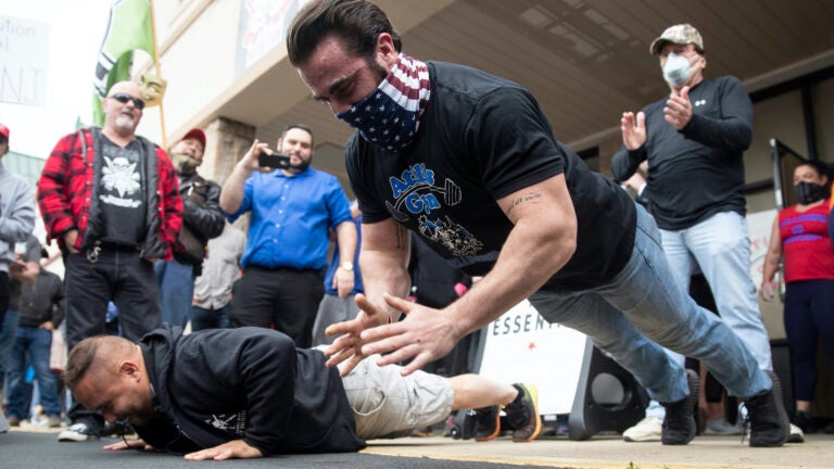 Atilis Gym co-owner Ian Smith does pushups outside the storefront in Bellmawr.