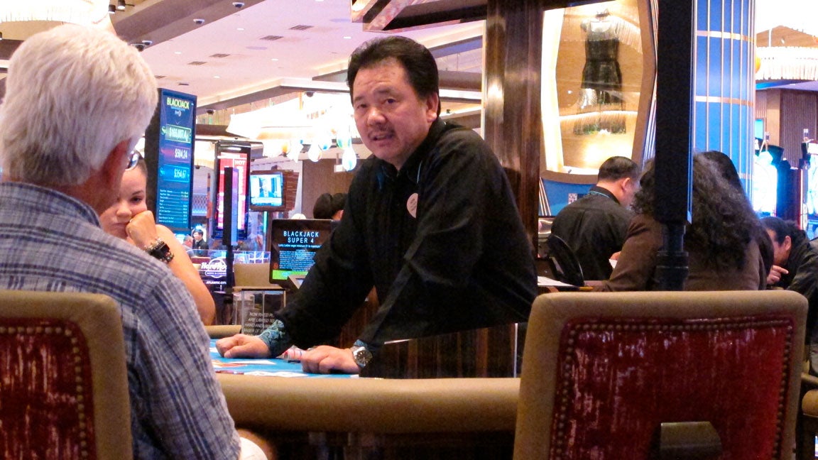 A dealer conducts a card game at the Hard Rock casino in Atlantic City