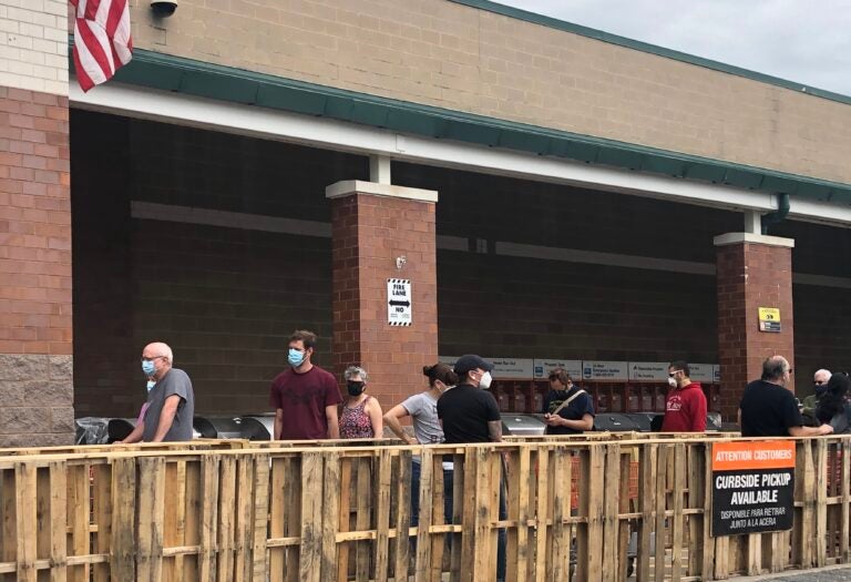 Customers lined up with masks and mostly maintained their distance Sunday at the Home Depot near Newark, Delaware. (Cris Barrish/WHYY)