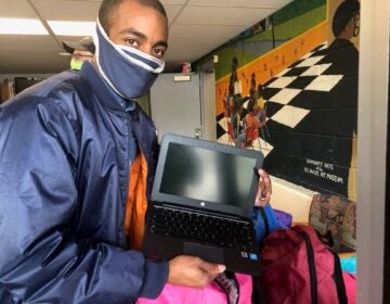 Markevis Gideon displays one of the devices his company gave to Kingswood preschoolers. (Cris Barrish/WHYY)