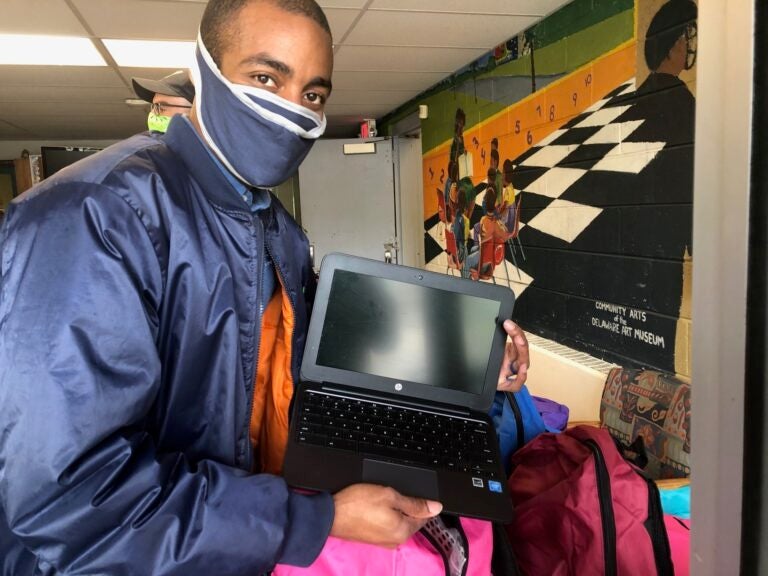 Markevis Gideon displays one of the devices his company gave to Kingswood preschoolers. (Cris Barrish/WHYY)