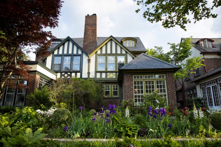 A garden bloom in front of a historic home in the Garden Court neighborhood. (Ryan M. Collerd for WHYY)