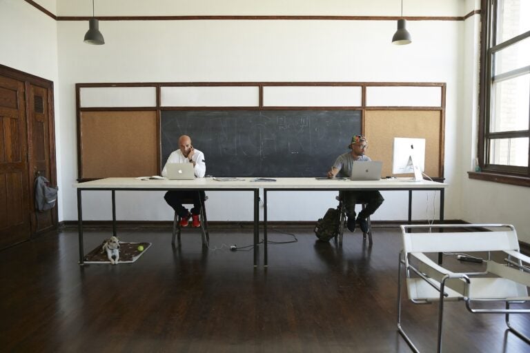 Two members of a tech startup located at Bok work on their computers. (Michael Persico) 