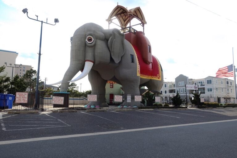 National Historic Landmark Lucy the Elephant is closed to visitors and the parking lot is empty in Margate, New Jersey, during the coronavirus pandemic while a flag flies at half staff on April 10, 2020. (AP Photo/Ted Shaffrey)