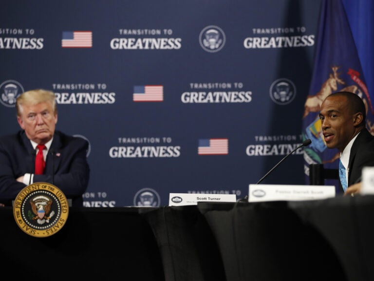 President Trump listens as Scott Turner, executive director of the White House Opportunity and Revitalization Council, speaks during a meeting with African American leaders in Michigan on Thursday. (Alex Brandon/AP Photo)