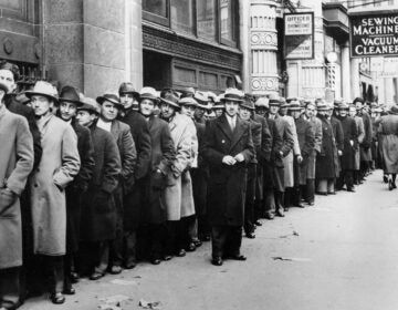 Unemployed people wait outside the state Labor Bureau in New York City in 1933.