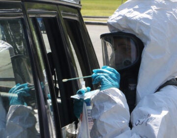 National Guard soldiers and airmen assist with a drive-thru COVID-19 testing site.