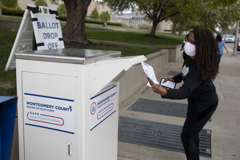 An Ohio voter drops off her ballot at the Board of Elections in Dayton, Ohio on April 28, 2020. Legal fights around mail-in voting are heating up as states turn to it amid the coronavirus pandemic. (Megan Jelinger/AFP via Getty Images)