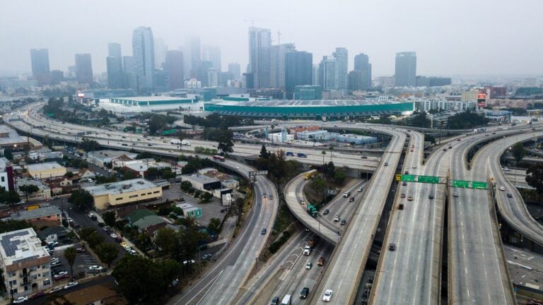 An aerial view shows downtown Los Angeles on April 30. U.S. miles driven decreased remarkably quickly in March, and driving slowly started to resume again — while remaining well below typical levels. (Robyn Beck/AFP via Getty Images)