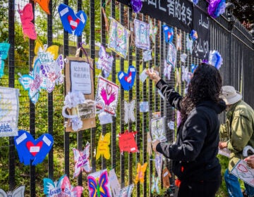 A volunteer artist sets up a memorial in Brooklyn on May 20. Artists and volunteer organizers across New York City put up physical memorials throughout the five boroughs in connection with Naming the Lost to honor the lives lost to COVID-19. (Erik McGregor/LightRocket via Getty Images)