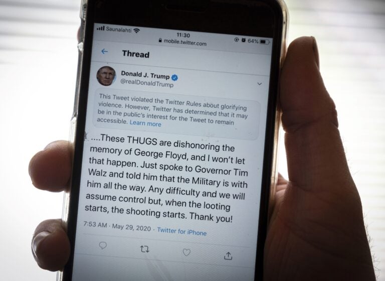 President Trump's Twitter page is displayed on a mobile phone. The social media company flagged one of his tweets about Minneapolis as 