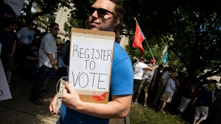 A voter registration volunteer in Philadelphia in 2018. New registrations had surged going into 2020 but have dropped off dramatically as a result of the coronavirus pandemic. (Dominick Reuter/AFP via Getty Images)