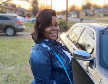 Breonna Taylor poses with her car on Dec. 25, 2019. Her friends and family remember Taylor as a caring person who loved her job in health care and playing cards with her aunts. (Taylor Family)