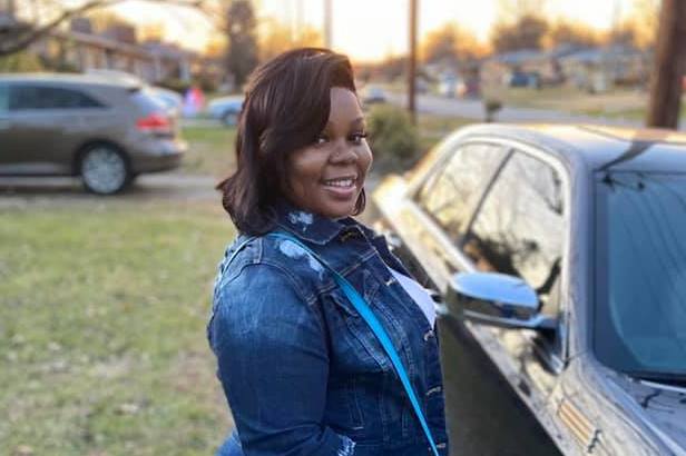 Breonna Taylor poses with her car on Dec. 25, 2019. Her friends and family remember Taylor as a caring person who loved her job in health care and playing cards with her aunts. (Taylor Family)