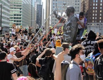 Protesters try to take down the statue of former mayor and police chief Frank Rizzo in front of the Municipal Services Building on May 30, 2020. (Emma Lee/WHYY)