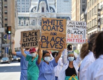Protesters in scrubs and lab coats