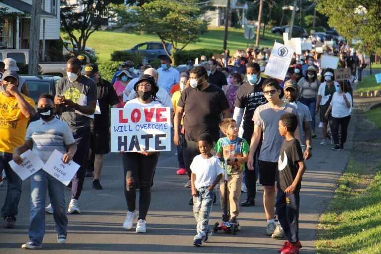 Hundreds march through the Linconia neighborhood of Bensalem Township to remember George Floyd and others who have died at the hands of the police. (Emma Lee/WHYY)